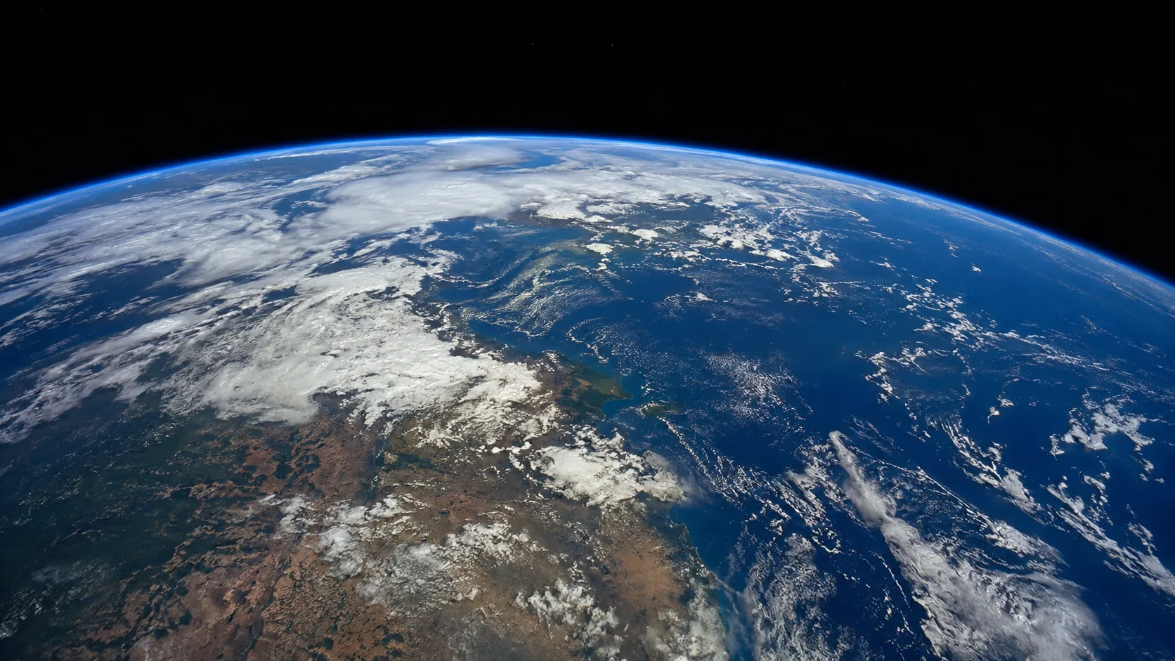 Earth observed from orbit, with oceans, land, and cloud cover along the planetary limb