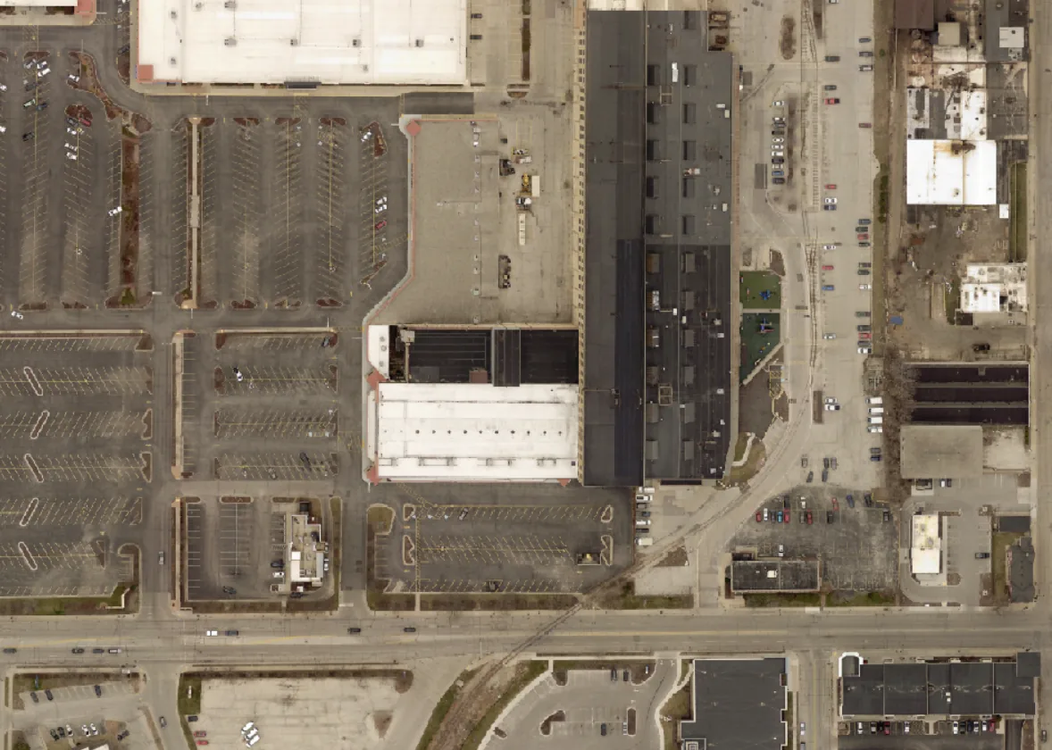 Overhead view of industrial buildings, parking lots, and roadways